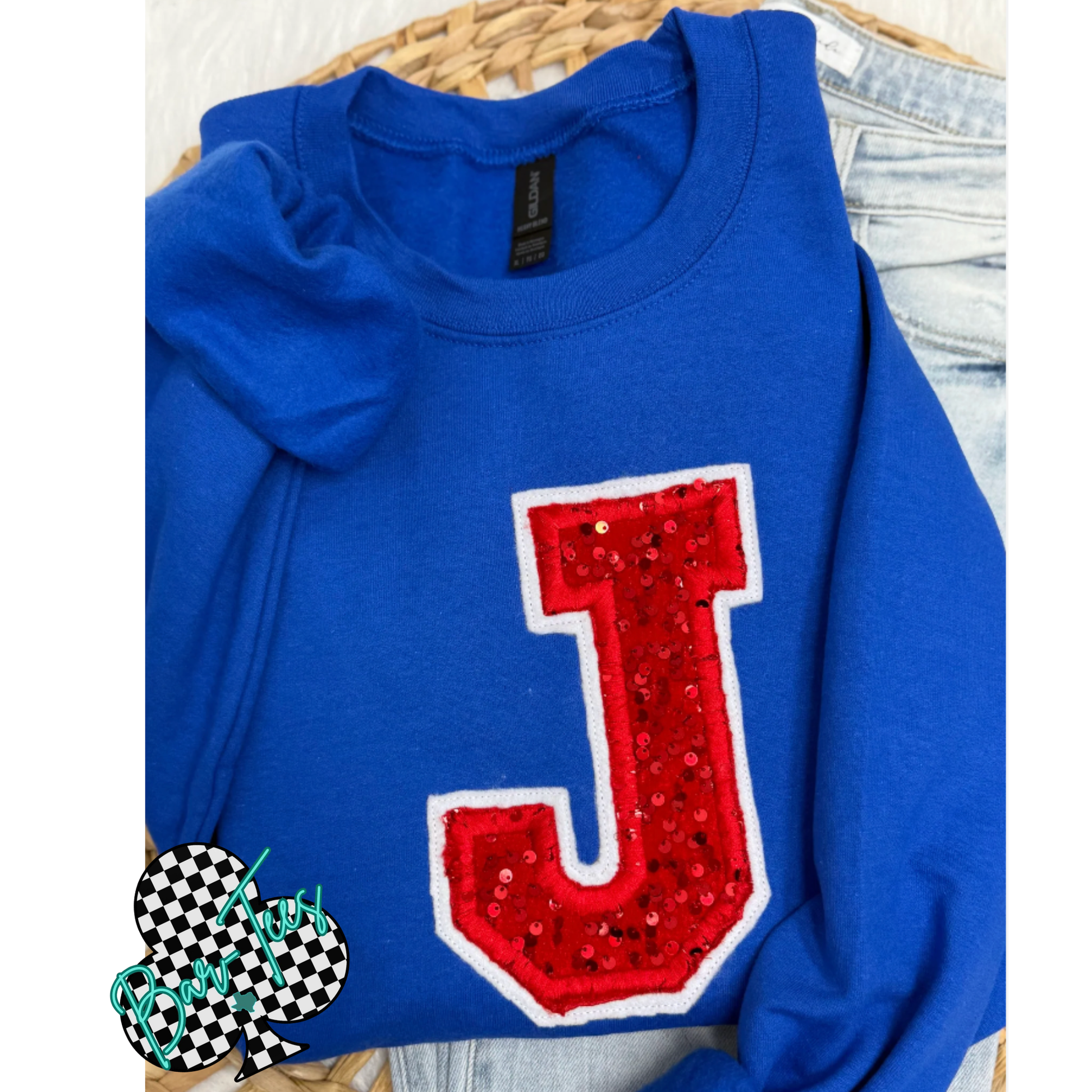 Blue sweatshirt with a red 'J' on a white background