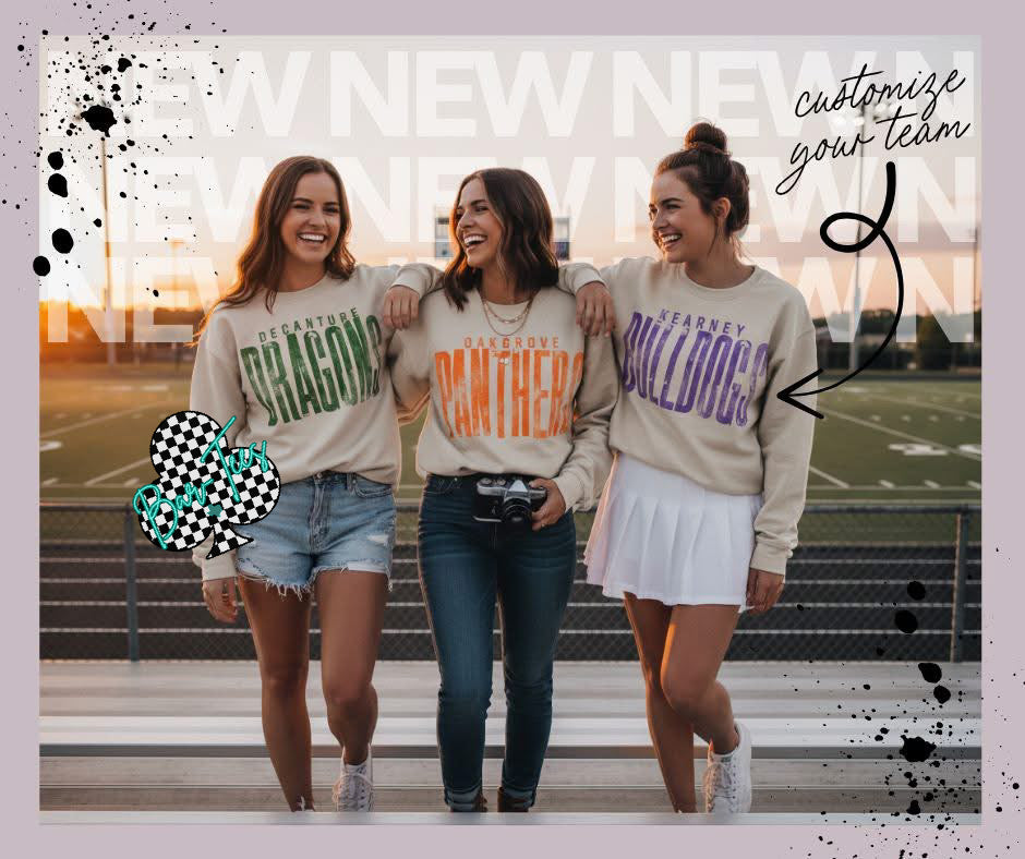 Three women wearing sports team-themed sweatshirts standing on steps outdoors.
