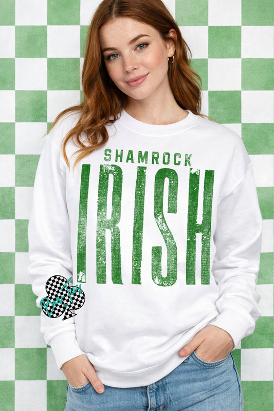Woman wearing a white sweatshirt with 'Shamrock Irish' text against a green and white checkered background